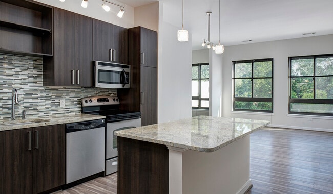 Large living area with wood flooring throughout