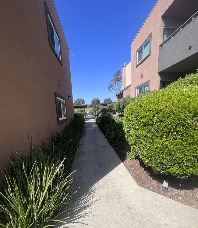 Walkway between apartment buildings at Villa Pacific Apartments in Oceanside, California.