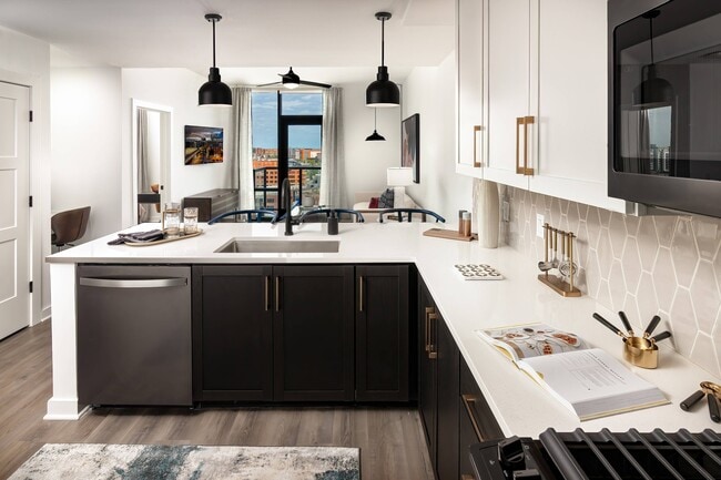 Kitchen with Gorgeous Tile Backsplash - Harlowe Apartments