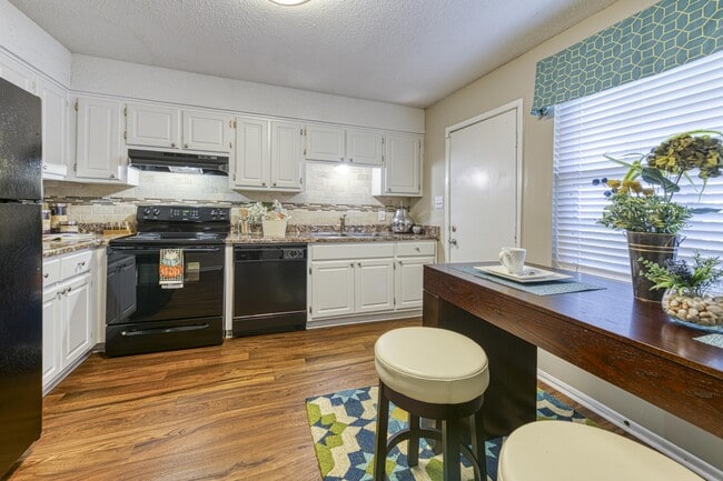 Kitchen with White Cabinets & Wood-style Floors - Ascent Jones Valley Apartments