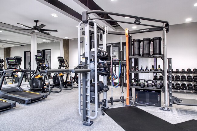 24-hour fitness center with cardio equipment and free weights