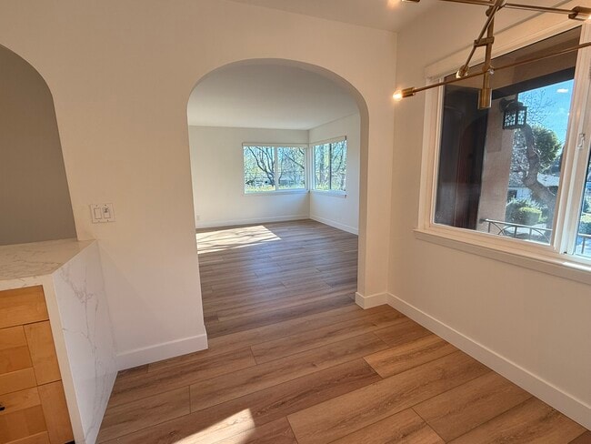 Dining area and living room in upstairs corner unit - 496 Sherwood Way Unit Apartment 3