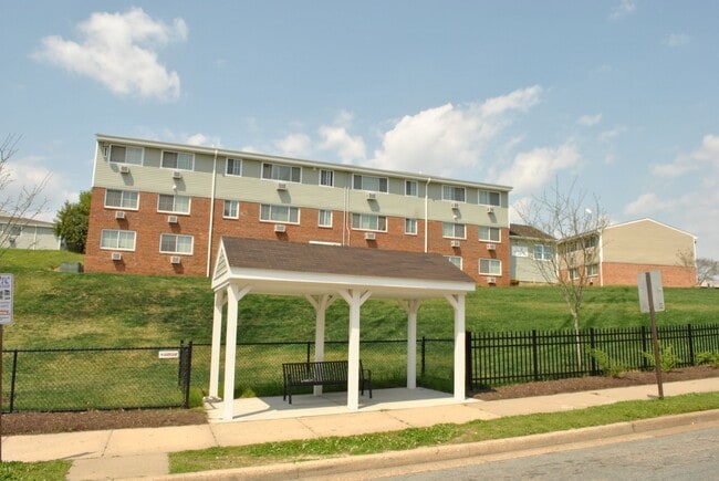 Oliver Crossing apartment community exterior with resident balconies and green space