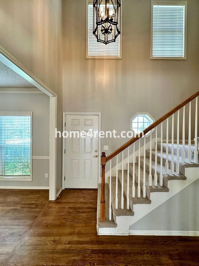 Photo - Beautiful Four-Bedroom Home with Three Car Garage, Wood Floors, Finished Basement and a Fenced Ya...