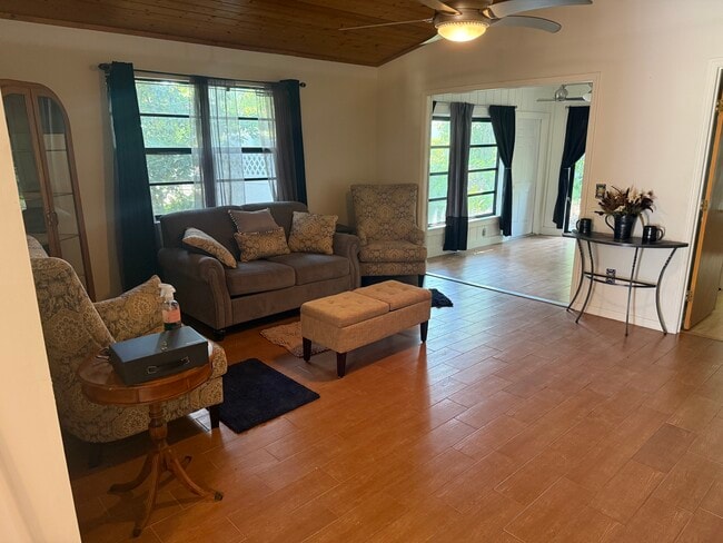 The spacious living room opens into a bright bonus room. - 6425 5th St House
