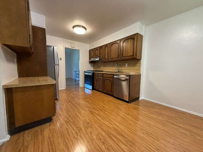 Photo - Spacious 4-Bedroom Home with Functional Layout, Backyard Access & Attached Garage
