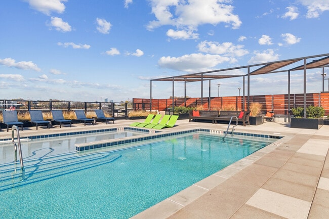 Catch some rays or cool off poolside with skyline views. - Residences at The Finery