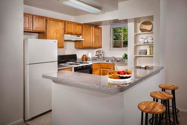 Well-equipped kitchen with breakfast bar at Gateway Square Apartments