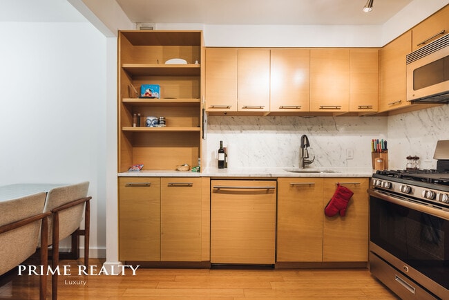 Sizable fully-equipped kitchen with extra-room for a dining table. - 100 W 39th St Unit 40E