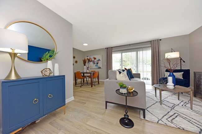 Spacious living room with hardwood-style flooring & overhead lighting