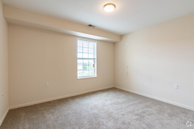 2BR,1BA - 825SF - Primary Bedroom - Glenwood Square Senior Apartments