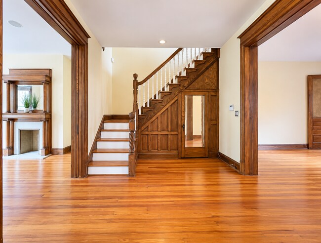 Beautiful original staircase & woodwork showcase the home's historic character. Storage under stairs