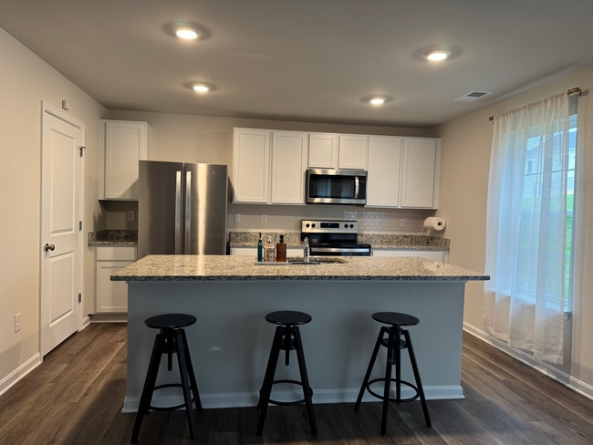 Granite countertop and island with stainless steel appliances - 377 Aylesbury Ln House
