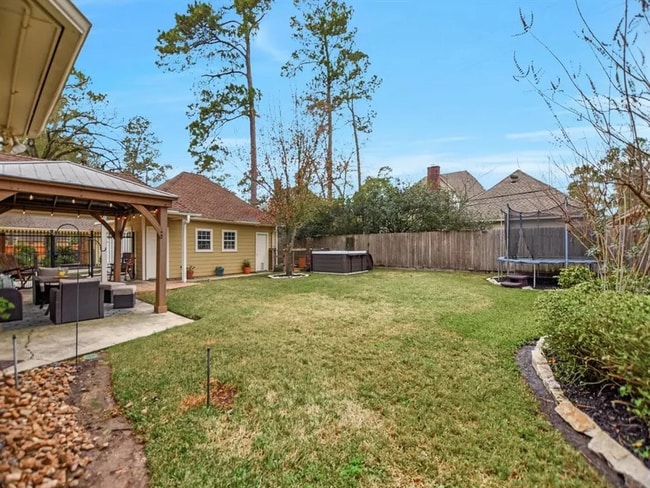 Spacious backyard with included hot tub! Trampoline belongs to previous tenant. - 6035 Spring Creek Grove Ln