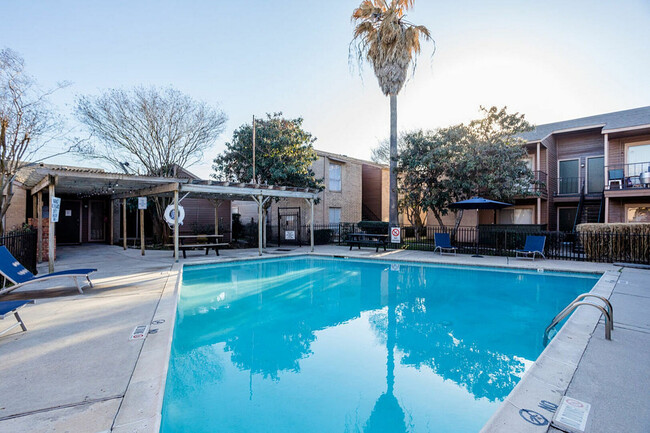 ake a refreshing swim in the sparkling pool, perfect for sunny days - Ridge Point Apartments