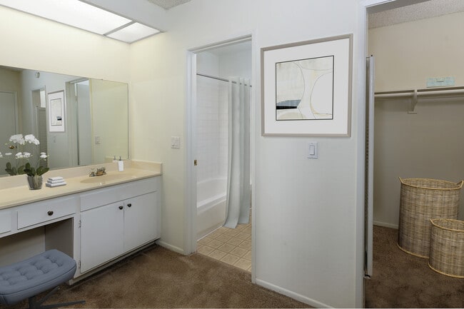 Classic bath with white cabinetry and tile flooring