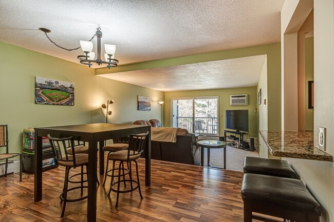 Dining Room into Living Room and Deck overlooking lake - 4860 Park Commons Dr Apartment Unit 217