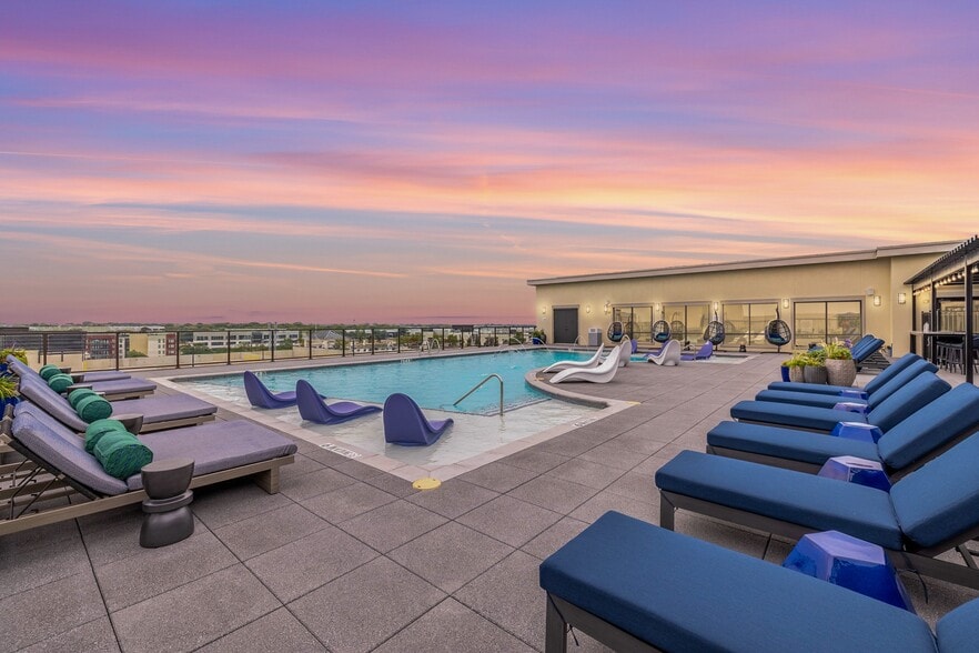 Rooftop Pool - Resort-style pool with sun shelf, cabanas and grills for relaxing and entertaining close to home.