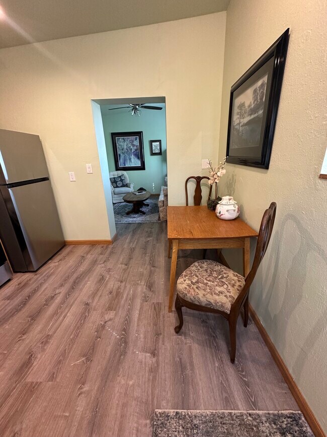 Dining room table and view into living room - 400 Main St Unit A