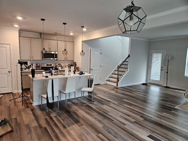 Modern townhome with high-end finishes throughout, minutes to 540 and walkable to great shopping.