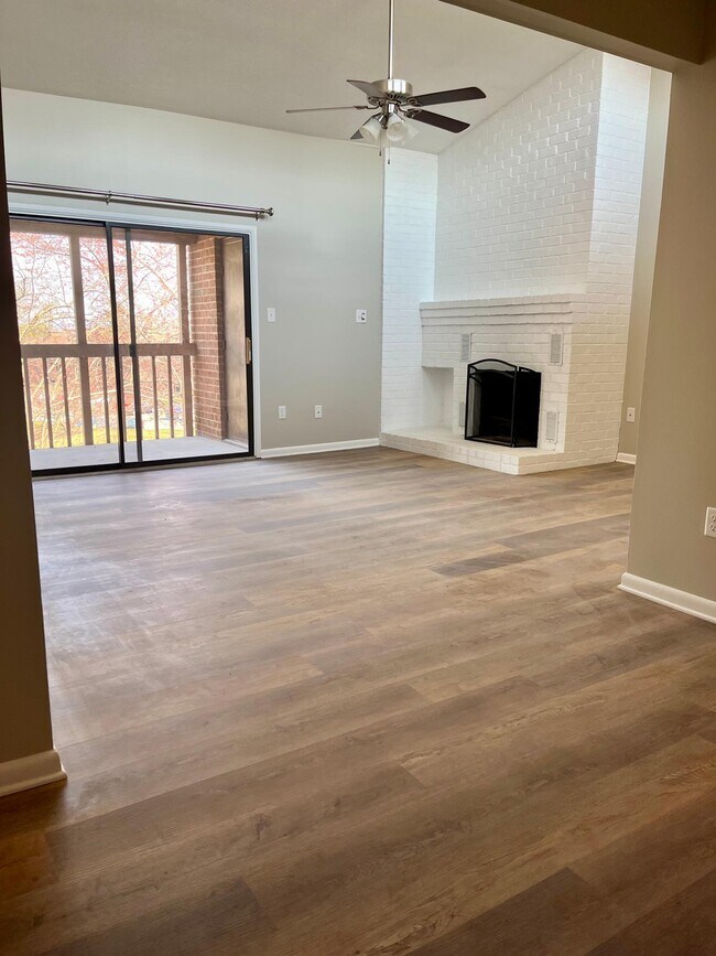 Dining room view to living room with vaulted ceilings