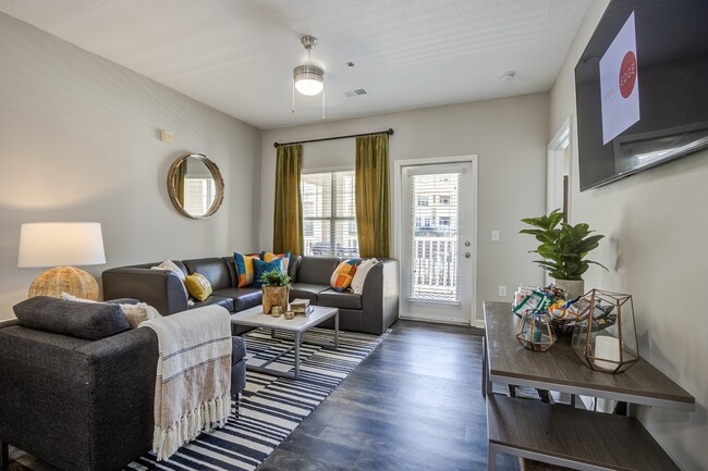 Campus-Edge-Apartments-Near-NC-State-University-Fully-Furnished-Living-Room-with-Patio-Access