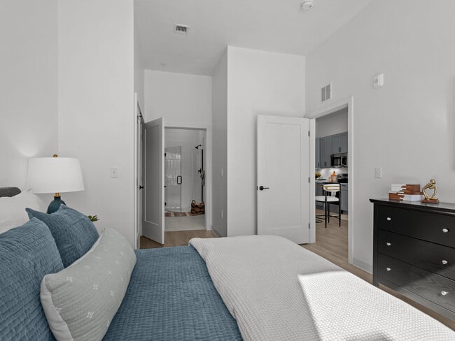 Spacious apartment bedroom featuring contemporary furnishings at The Elmwood