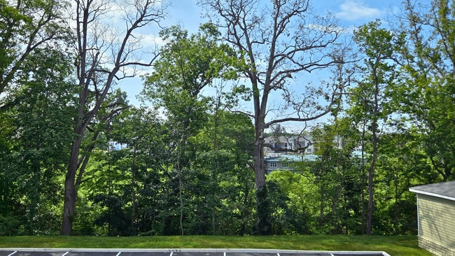 Enjoy wooded views from your new patio/balcony, available at select units at Greenwood Commons Apartments.
