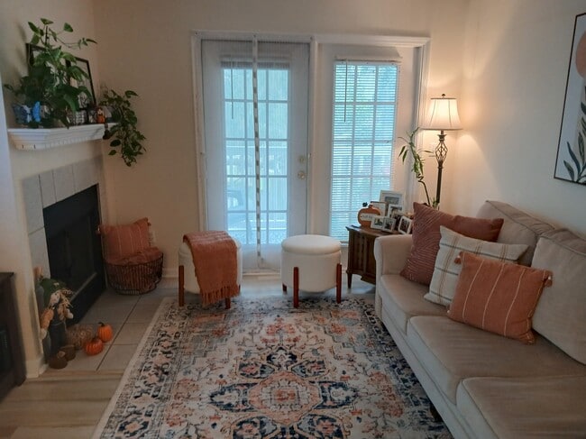 Living room with french doors to deck - 100 Kensington Blvd Unit 824