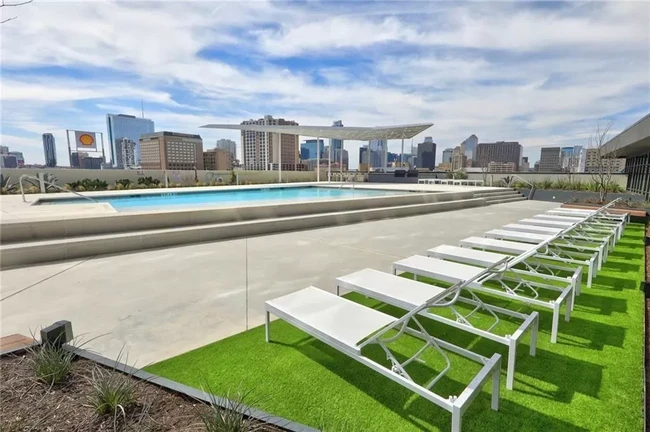 Pool with downtown skyline view + grill area - 800 Embassy Dr Condo Unit 107