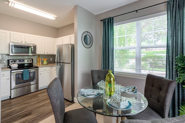 White cabinets with stainless steel microwave, stove and refrigerator. - Hawthorne Commons Apartments