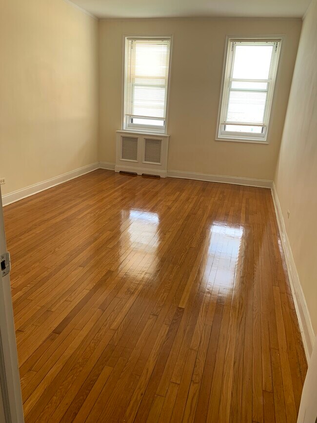 Bedroom with redone hardwood floors and custom radiator cover - 286 Corbin Plz Unit 2C