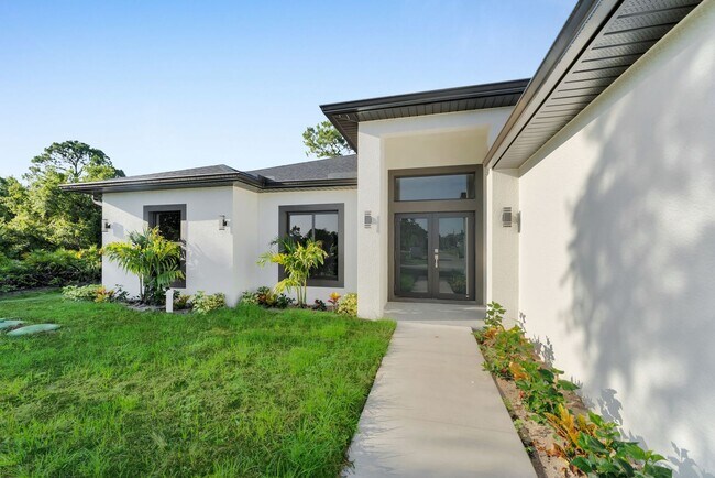 Building Photo - Brand-New Home in Lehigh Acres – Move-In Ready! FL 33974. Qualify for a deposit-free option and s...