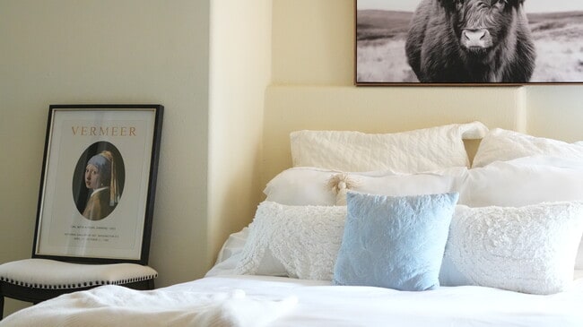 The bedroom with the view has a window that allows natural light to come in and illuminate the room. - 4160 Barrett Rd Unit Charming Abode Rental