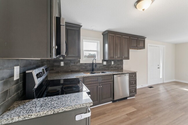 Building Photo - This cozy residence features a bright living space and well-appointed kitchen.  1st month is FREE...
