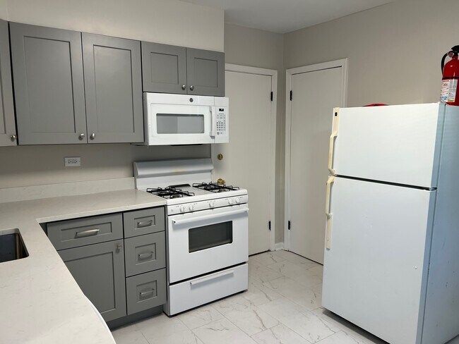 Kichen looking towards rear exit and storage closet - 812 Beloit Ave Unit 1