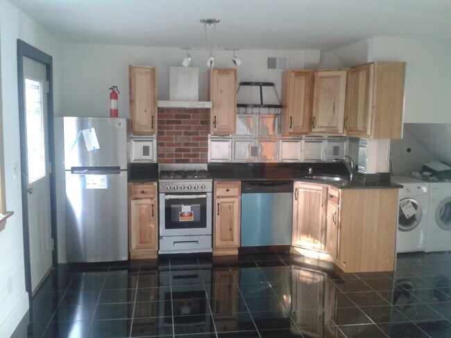 Kitchen with walk out to garden/patio attached to living room, dining room open space - 52 Church St Apartments Unit Second floor