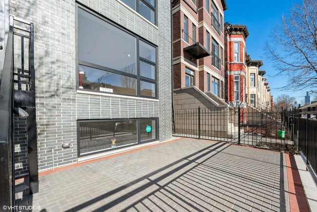 Front facade and front bricked enclosedpatio - 2238 W Warren Blvd Apartments Unit #1