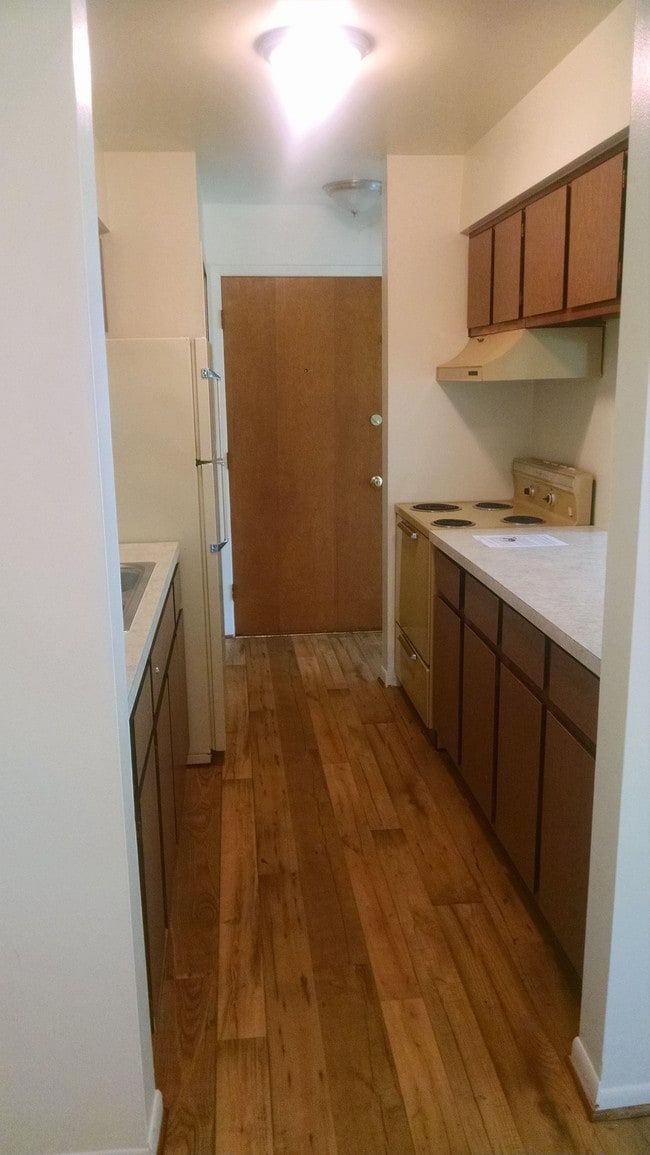 Kitchen, looking towards front door - Pinecrest Apartments