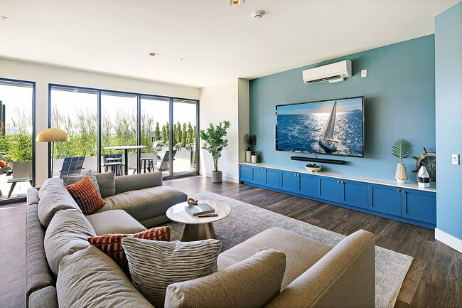 Experience comfort and style in this sunlit living area, perfect for relaxation and entertainment. - Waterfront Place