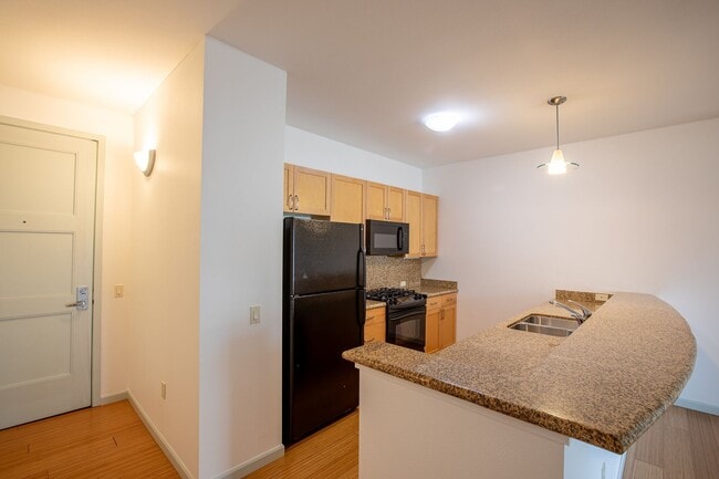 Photo - Sweet + secure 1/1 condo with parking, extra storage room + AC available now! Unit 206