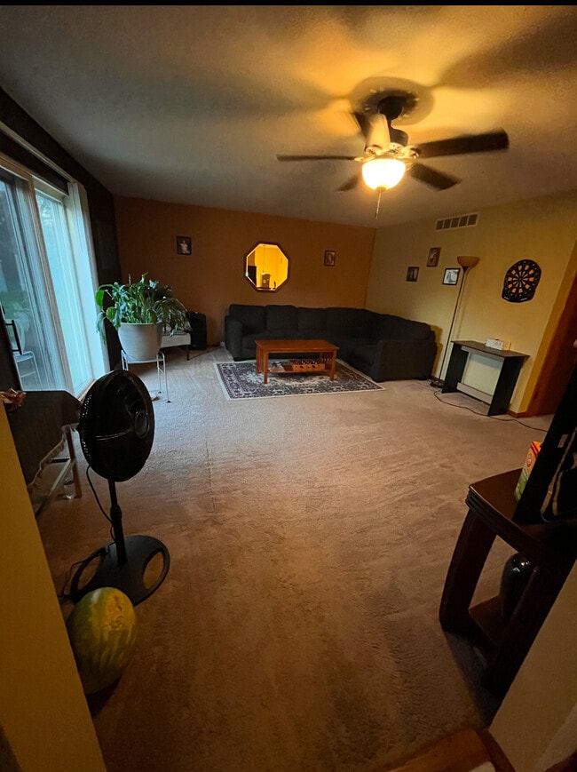 Large living room with sliding door to deck - 4300 E 73rd Ave Unit Large Secluded Apartment