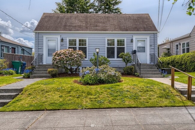 Building Photo - "Charming 3-Bedroom Duplex with Granite Touches & Gleaming Hardwood Floors in Seattle's Vibrant B...