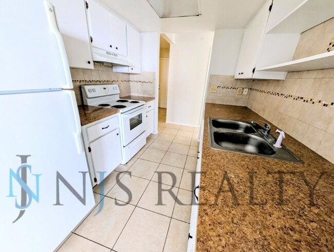 Photo - Beautifully updated 3/2/2 1500 Sq. Ft. with fenced yard, tile floors, HUGE living room and a corn...