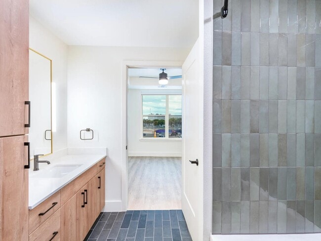 Modern finishes and premium details such as Brizo faucets create a bathroom that’s stylish and functional.