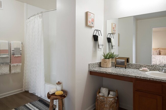 Start your day in a spacious bathroom featuring granite countertops and modern design at The Preserve at Tuscaloosa.