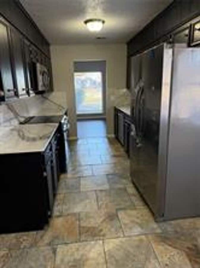 Photo - 2 story house for lease. Open floor plan in kitchen & living. Lots of storage. Large fenced backy...