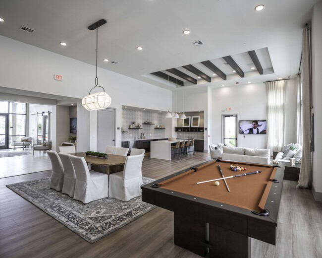 Expansive clubroom with gathering space, lounge seating, and billiards. - Beckett West Fork Apartments