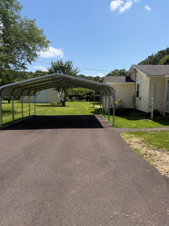 Photo - Charming 2-Bedroom Home with an Enclosed Sunroom & Peaceful Outdoor Living