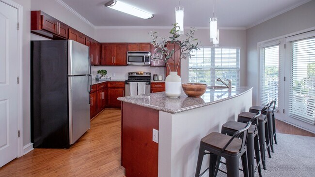 Entertain in style with our two-bedroom kitchens, boasting cherry wood cabinets and luxurious granite countertops for the perfect ambiance.